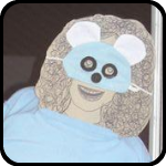 A Cardboard Woman Wearing A Blue Mouse Mask