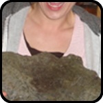 Woman Holding a Heavy Stone That Looks Like a Face Woman Holding a Heavy Stone That Looks Like a Face