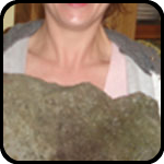 Woman Holding a Heavy Stone That Looks Like a Face Woman Holding a Heavy Stone That Looks Like a Face